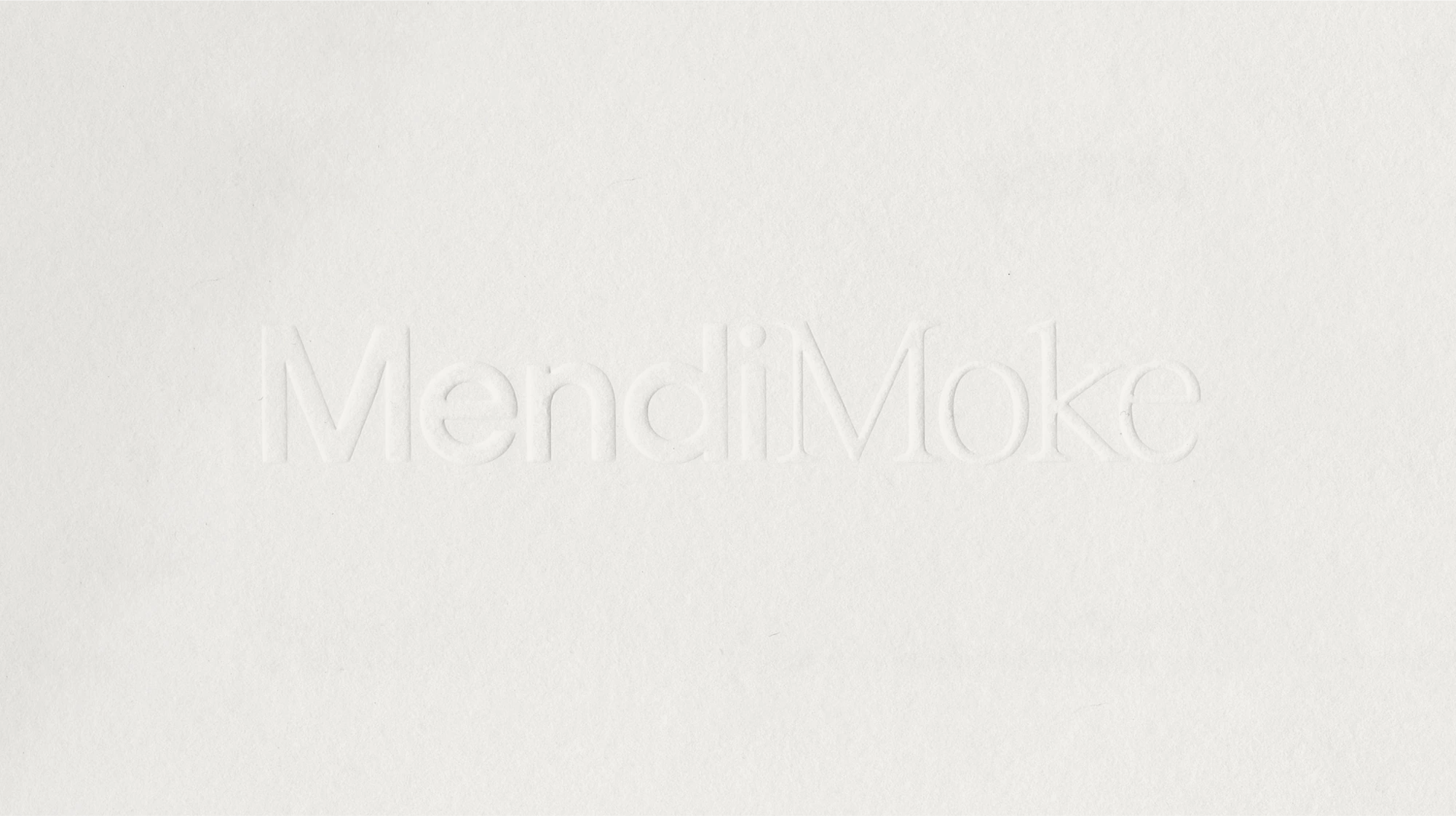 Branding Design for Mendi Moke, the wordmark blind embossed on white paper