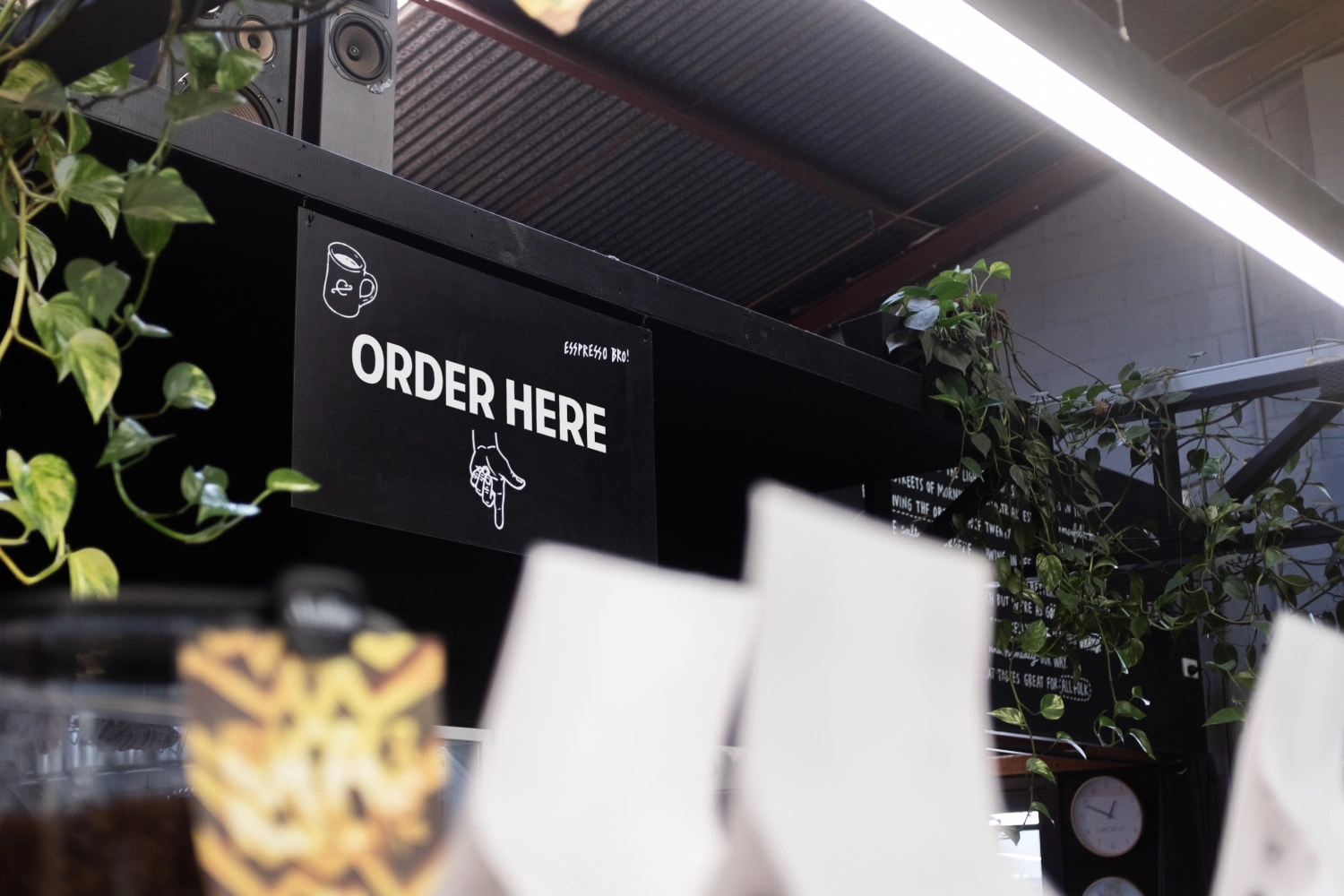 Signage Design for Commonfolk: an Order Here sign hanging in the cafe