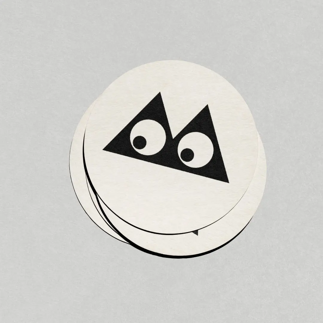 A logo mark with two eyes on a stack of round cards