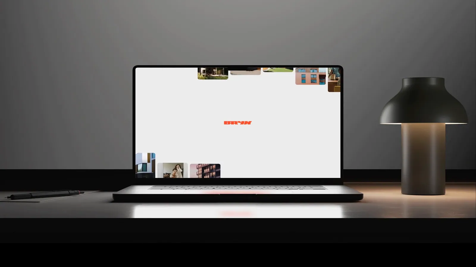 Website Design for Bryx on a laptop beside a desk lamp